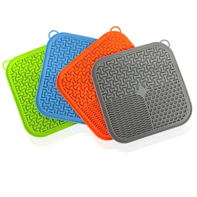Orange and grey dog licking mat with textured surface and suction cups on back