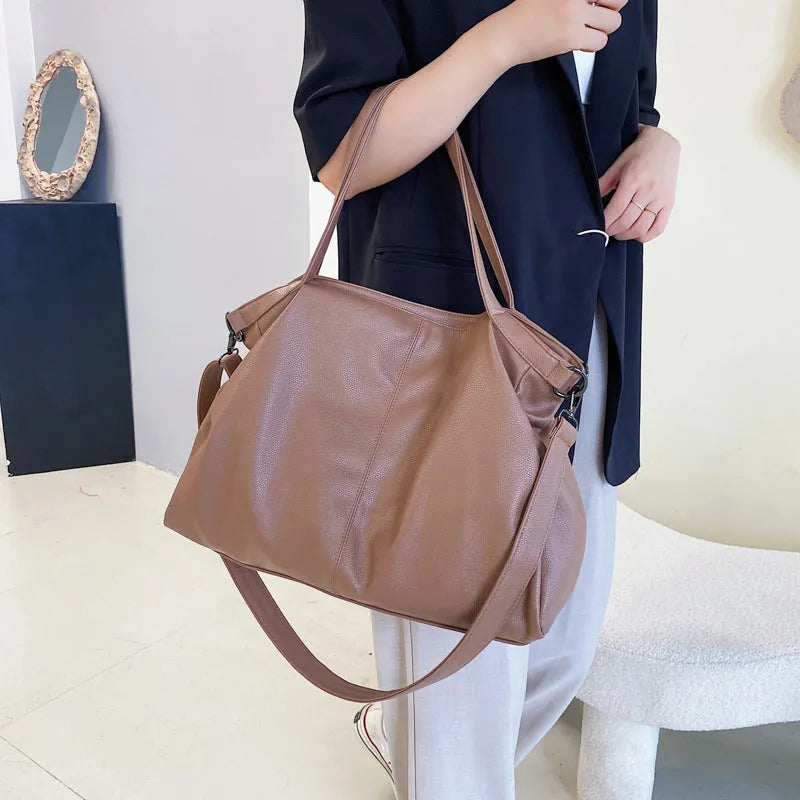 Large soft surface PU messenger tote bag in a horizontal square shape with a zip top and long shoulder strap.