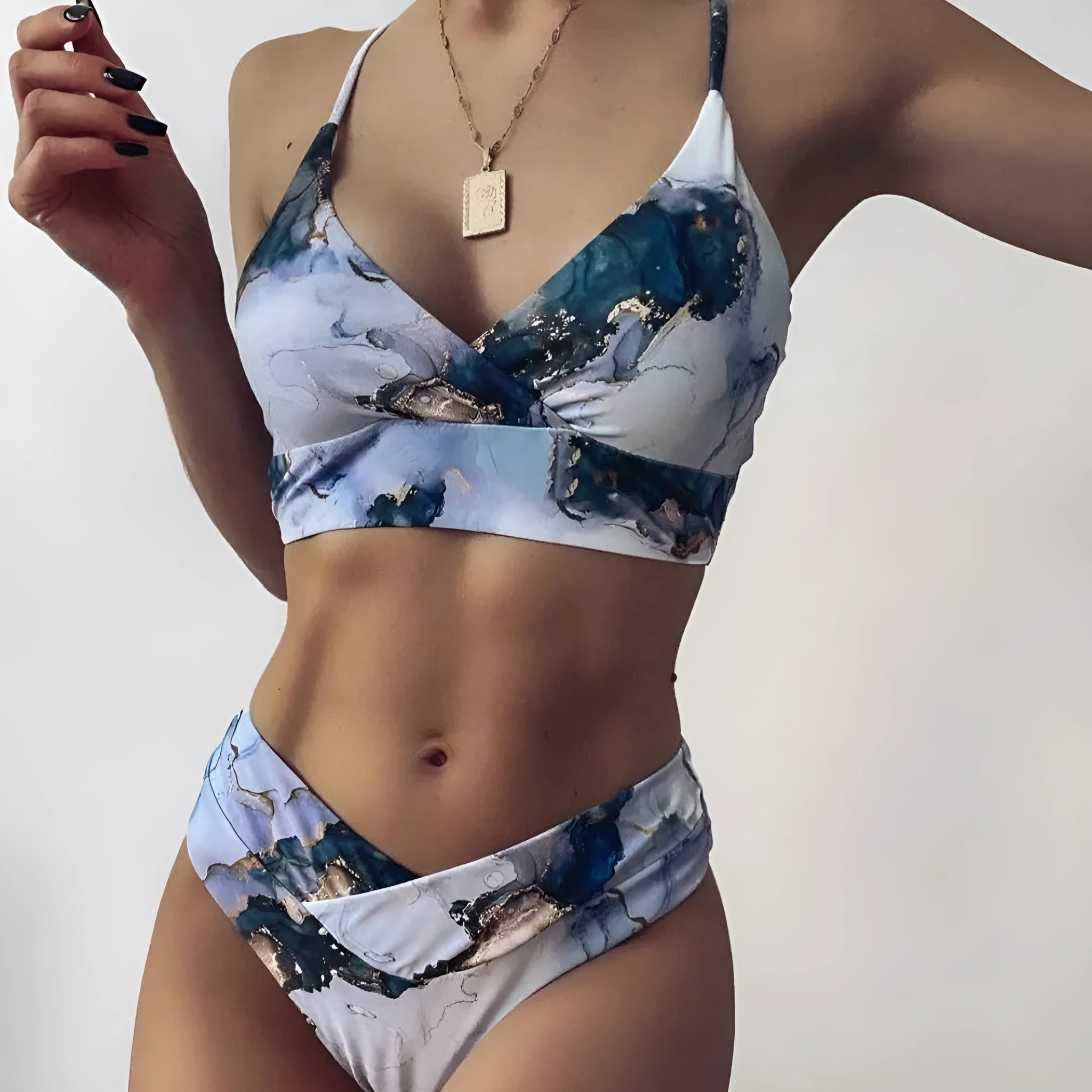 Women's marble print high-waist bikini set in blue tie-dye pattern for swimming.
