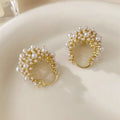 Gold-coloured copper flower basket earrings for women with small bead detailing and pearl inlay.