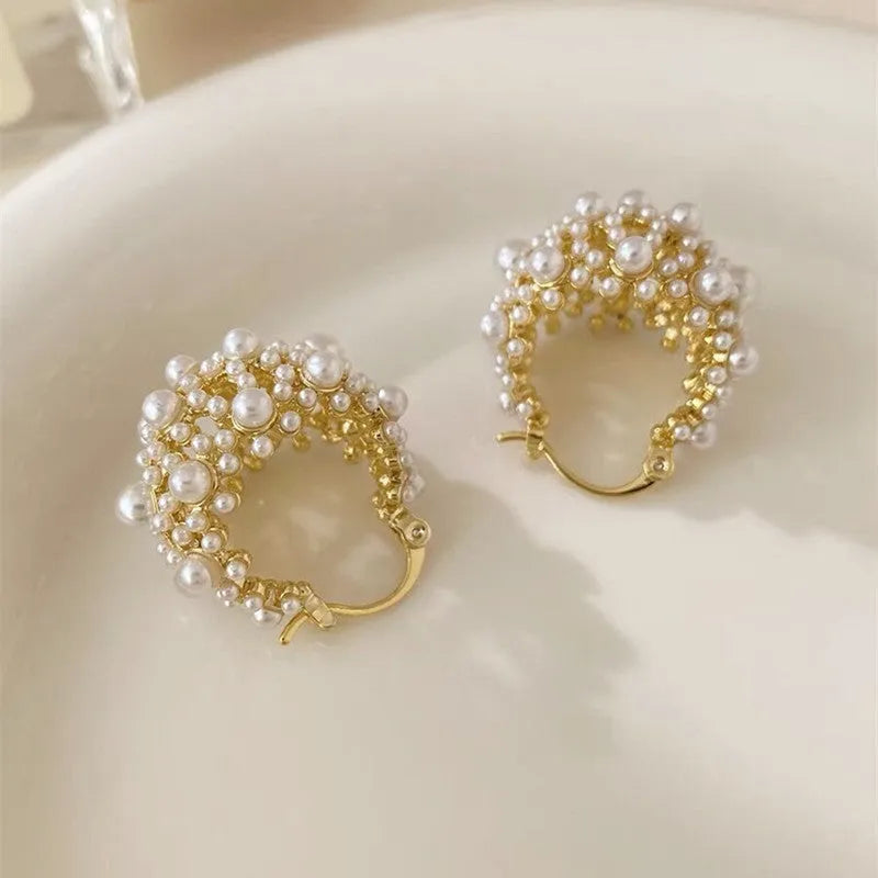 Gold-coloured copper flower basket earrings for women with small bead detailing and pearl inlay.