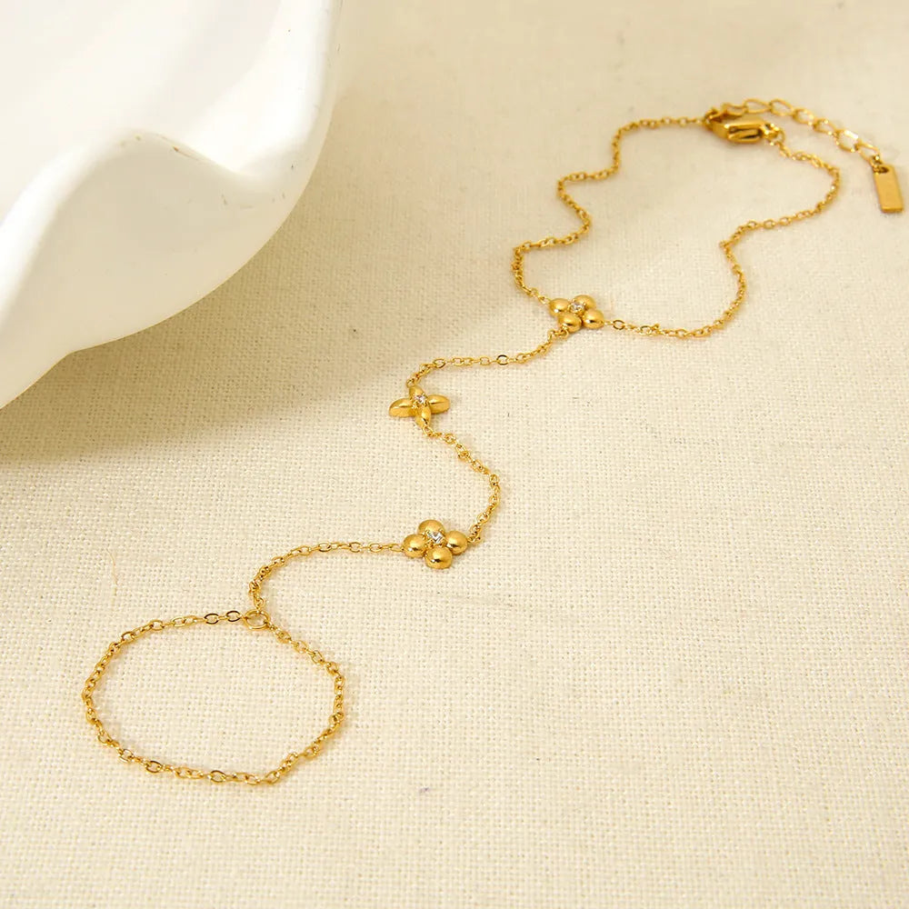 Gold geometric women's bracelet with floral and eight-pointed star design elements