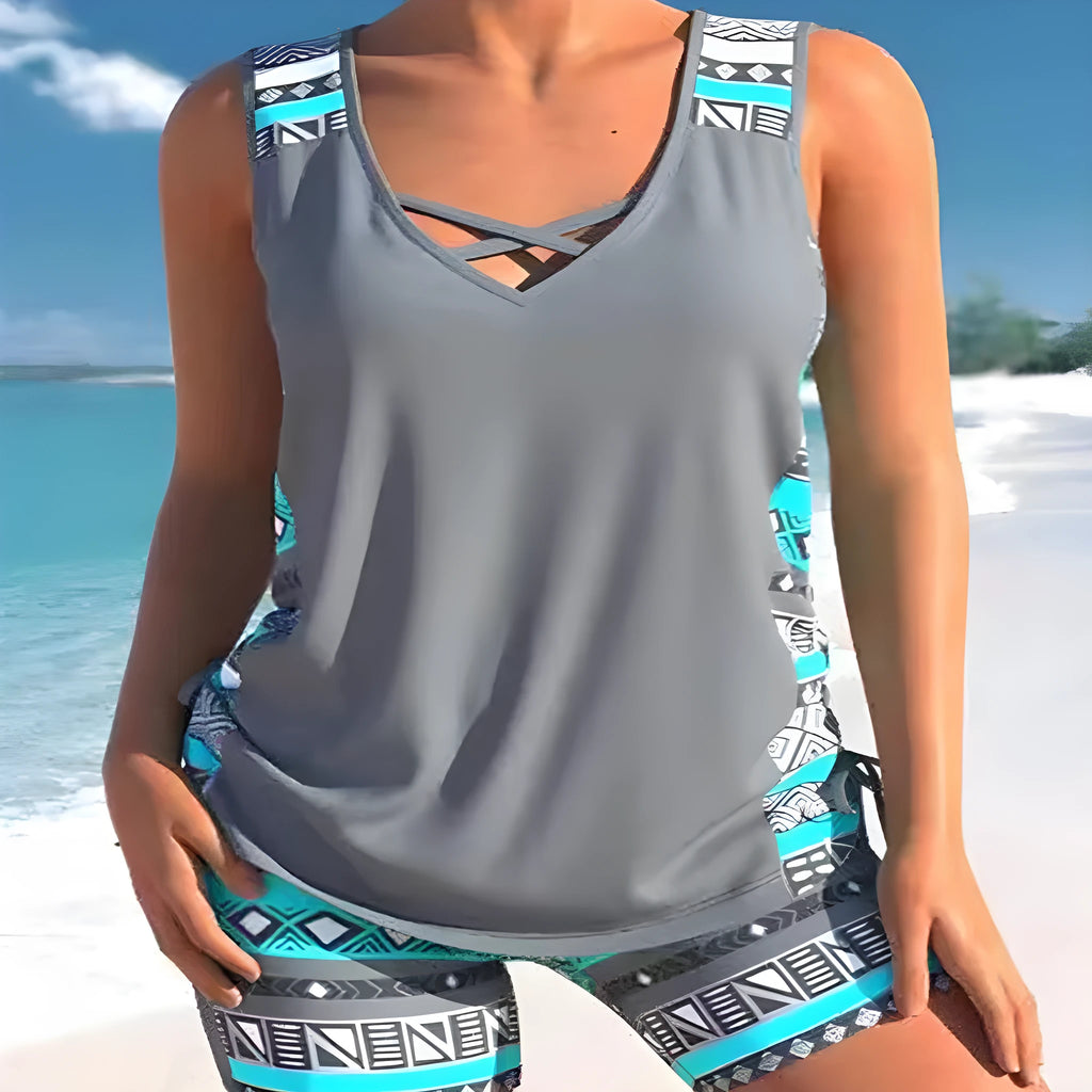 Women's blue printed lace two-piece swimsuit with a sleeveless top and brief shorts.