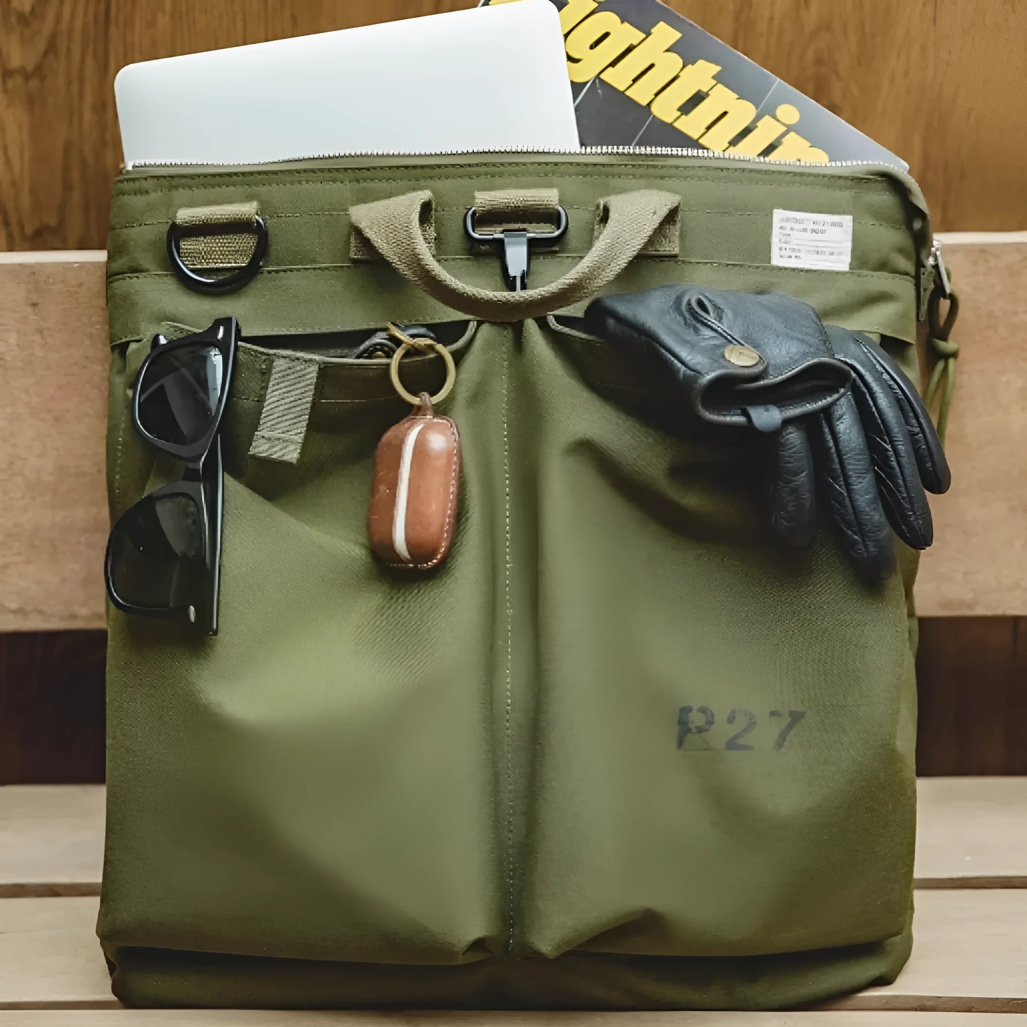 Medium nylon canvas messenger bag in military green with crossbody strap and laptop compartment