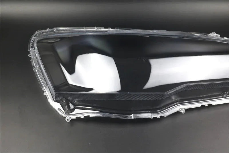 Clear plastic car headlight housing cover with dimensions 50mm by 30mm by 20mm.