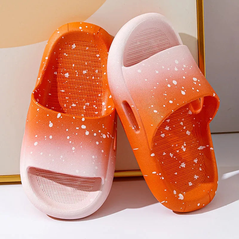 Gradient blue children's PVC summer slippers with a non-slip sole on a wooden deck.