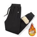 Men's grey fleece-lined oversized track pants with elastic waistband and straight leg cut