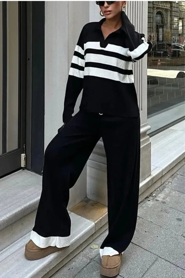 Women's black and white striped knitted polo shirt and trouser two-piece set.