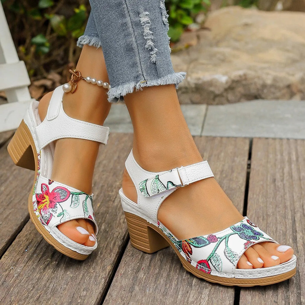 White women's high heel sandals with adjustable Velcro buckle strap on a rubber sole.
