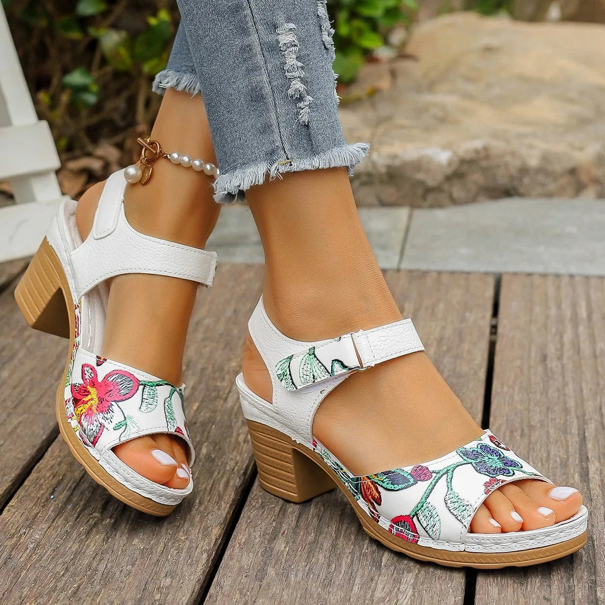 White women's high heel sandals with adjustable Velcro buckle strap on a rubber sole.