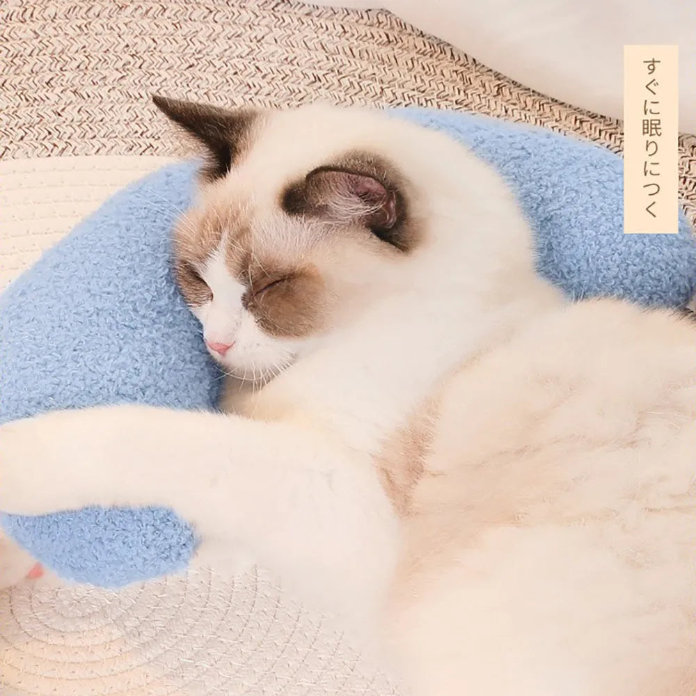 U-shaped blue cat pillow with adjustable white collar on a blanket