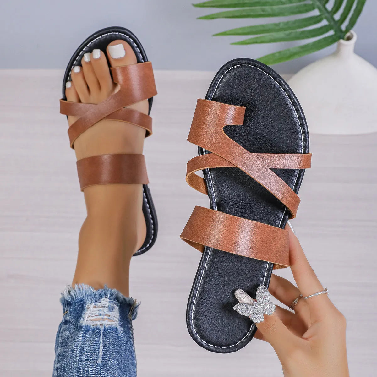 Adult beach slippers in black with a hollow-out design, artificial PU upper, and rubber sole.