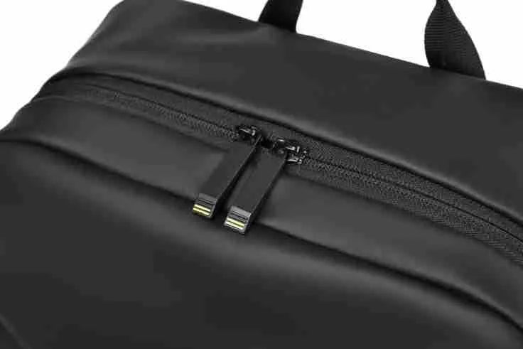 Large waterproof backpack in black with sewing thread detailing and included computer bag