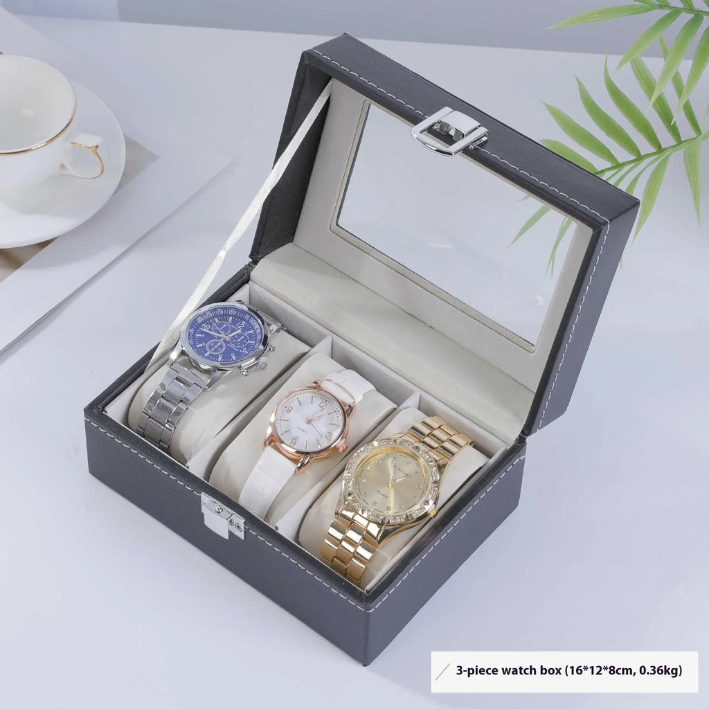 Grey high-grade leather watch storage box with a clear, dustproof lid on a table.