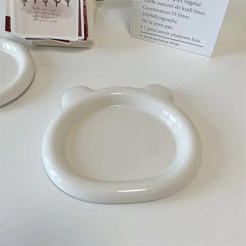 White ceramic ins-style plate with doodle design, shown in bear and round patterns in two sizes.