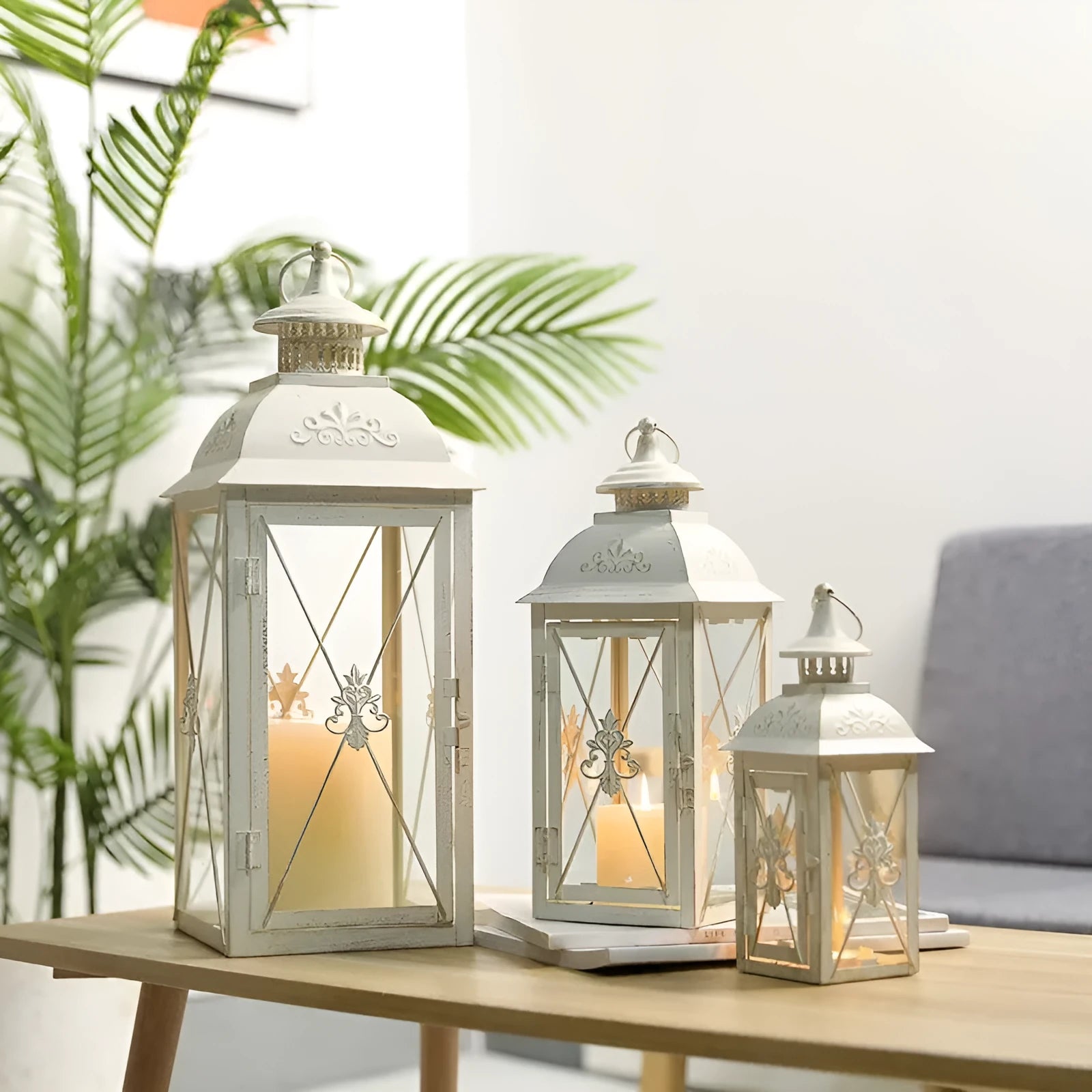Black and white wrought iron floor-standing storm lantern with tempered glass panes for garden decoration.