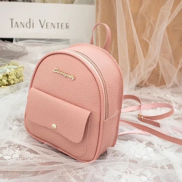 Small black PU women's backpack with zip closure shown as shoulder bag and backpack