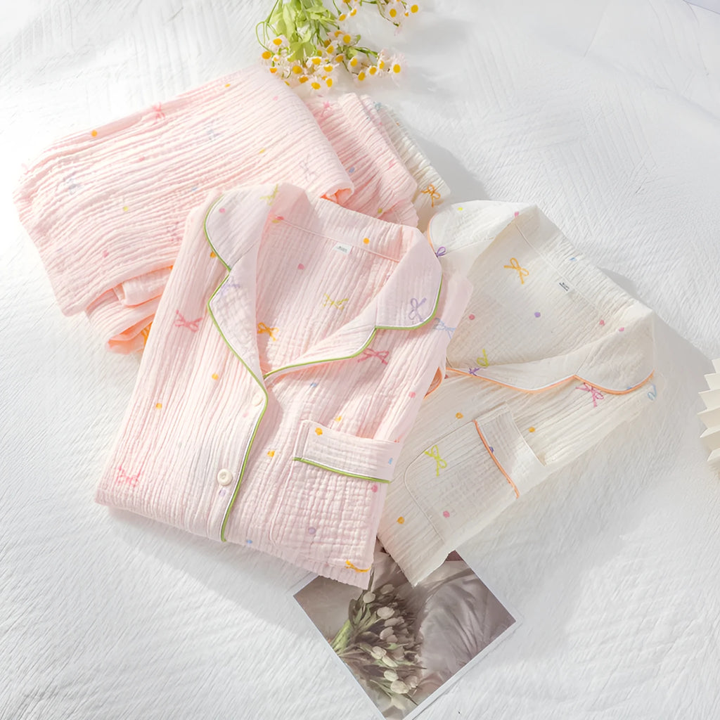 Women's cotton pajamas set in pink with long sleeves and trousers on hanger
