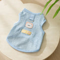 Green knitted cat clothing with a bear patch and breathable hollowed-out design on a cat model.
