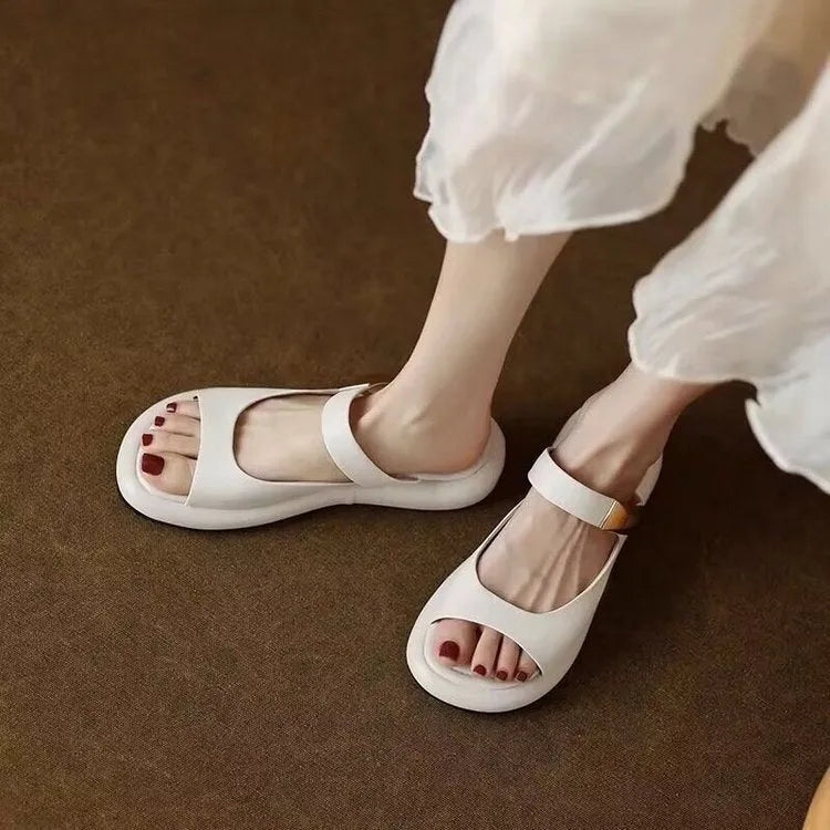 Women's apricot peep toe flat platform sandals with a rubber sole on a white background.