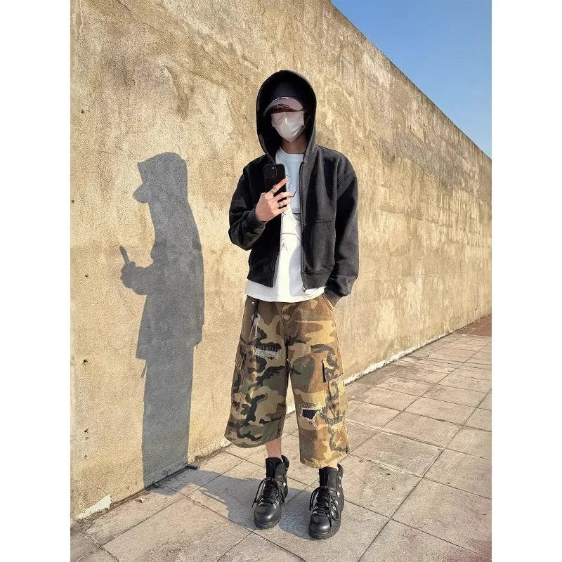 Men's camouflage cropped jeans with retro patches and ripped detailing on straight leg trousers