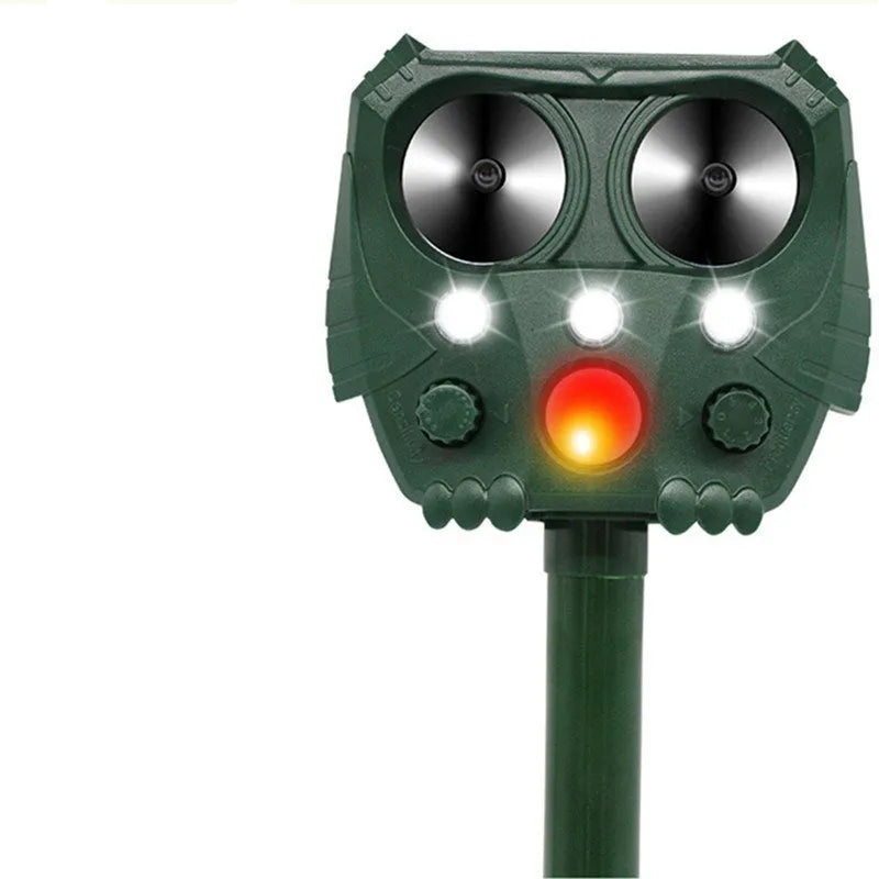Green solar-powered ultrasonic dog and pest repeller unit for outdoor mounting