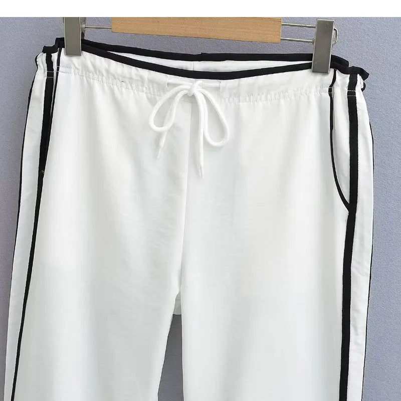 Navy blue loose straight leg drape pants with a low waist and thin fabric, laid flat.