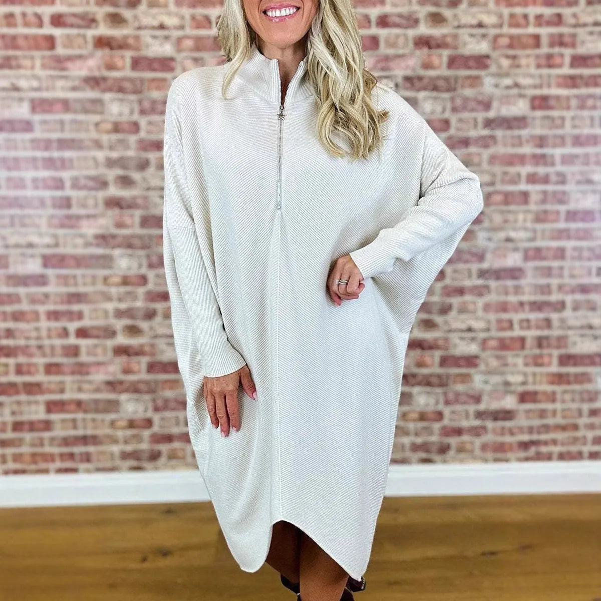 Women's solid colour knitted loose dress with front zip and raglan sleeves.