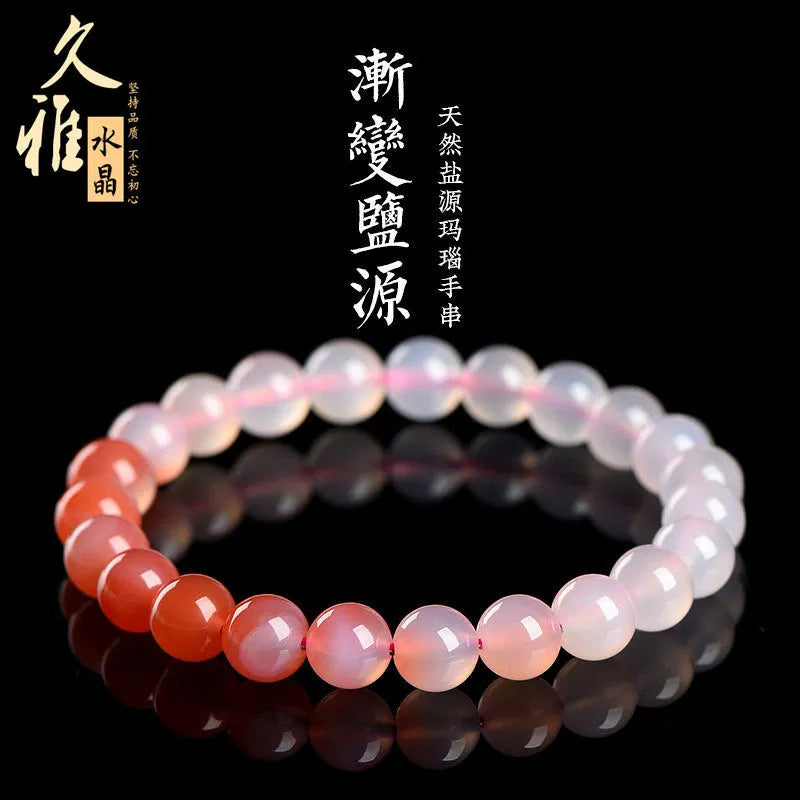 Natural gradient Yanyuan agate bracelet with smooth geometric beads on a wrist.