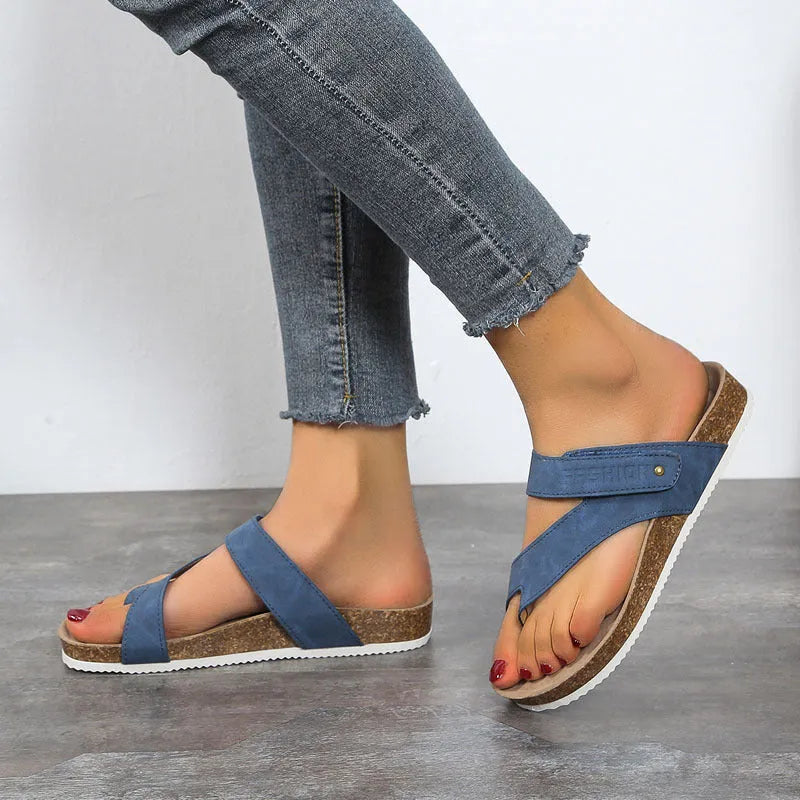 Women's blue flip-flops with a thick foam sole and a flat toe ring design on a solid colour artificial PU upper.