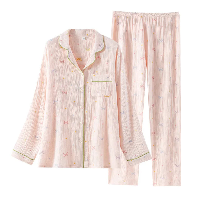 Women's cotton pajamas set in pink with long sleeves and trousers on hanger