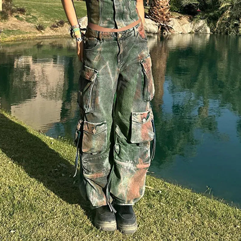 Women's loose cargo denim trousers with a colour bloom wash and gradient colour pockets on a street style background.