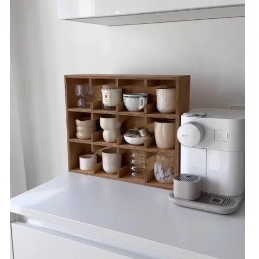 Solid square wood storage rack with multiple grid compartments for cups and mugs in birch wood colour.