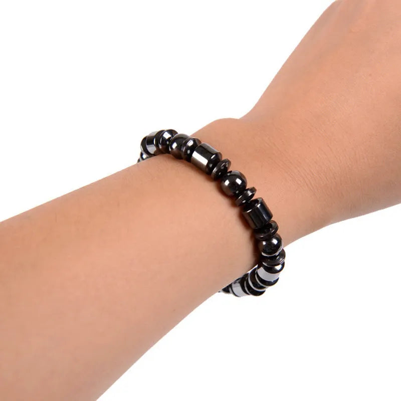 Black pentagram magnetic therapy bracelet with magnetite and hematite beads on wrist