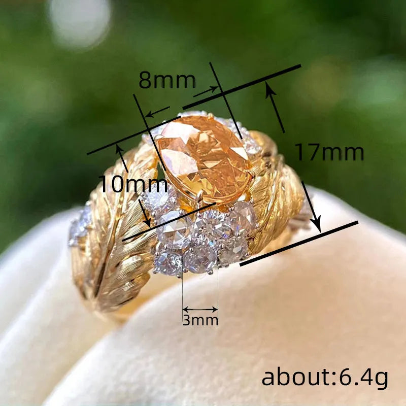 Embossed feather pattern gold ring with yellow zircon stone in geometric setting