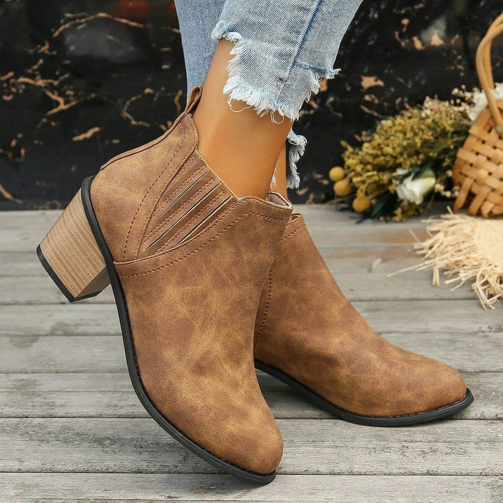 Women's black pointed toe ankle boots with thick square low heel slip-on design
