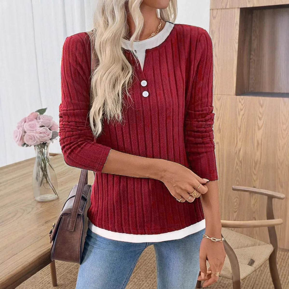 Women's black fake two-piece pullover sweater with round neck and button detail on concave stripe fabric