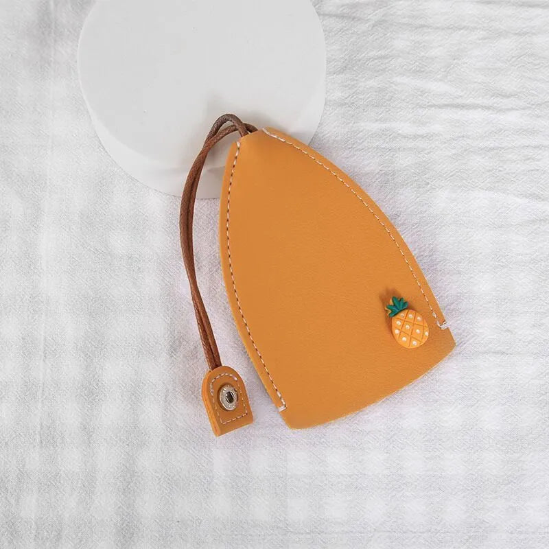 Colourful cartoon pull-out key protector case made from PU leather, showing a selection of fruit and animal designs.