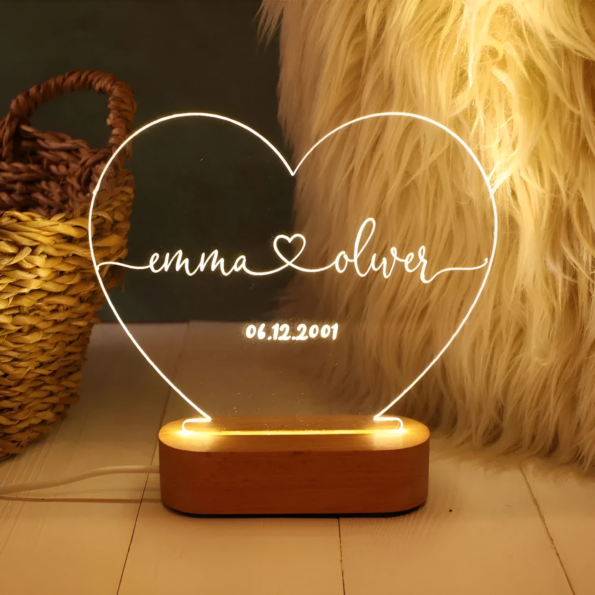 Custom engraved acrylic night light displaying personal names and a date, lit from a base LED.