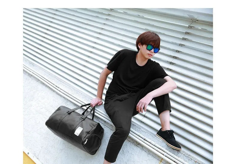 Black waterproof sports bag with diagonal strap and separate shoe compartment