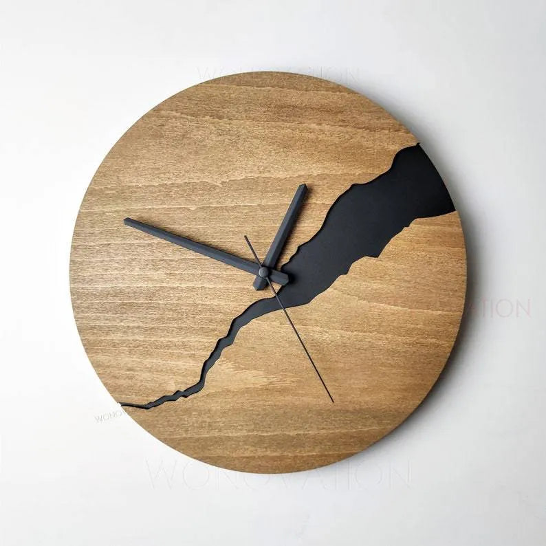Modern round wooden wall clock with crackle design, white face, and black hands.