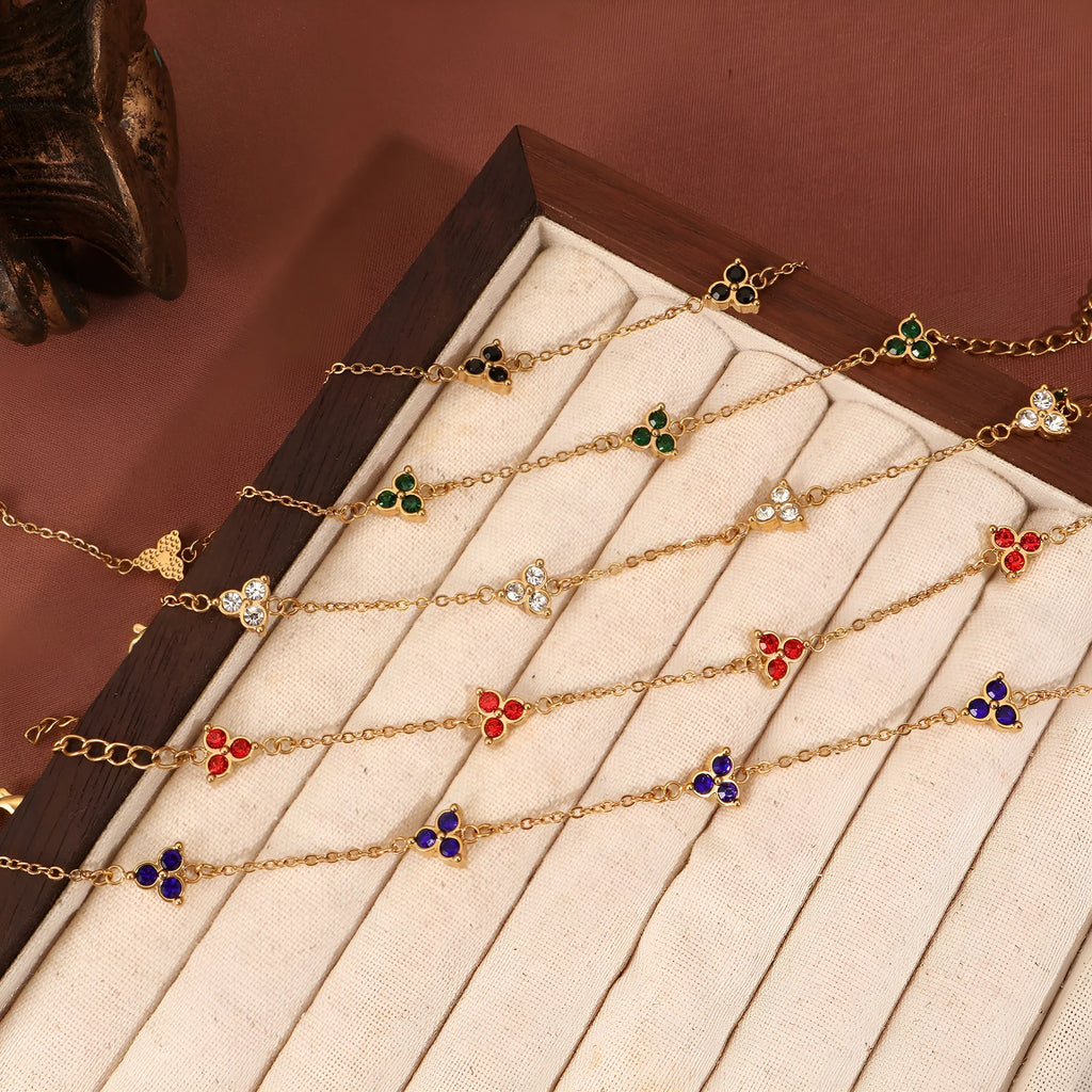 Women's geometric stainless steel bracelet with triangular diamond elements in gold or steel finish with coloured stones.