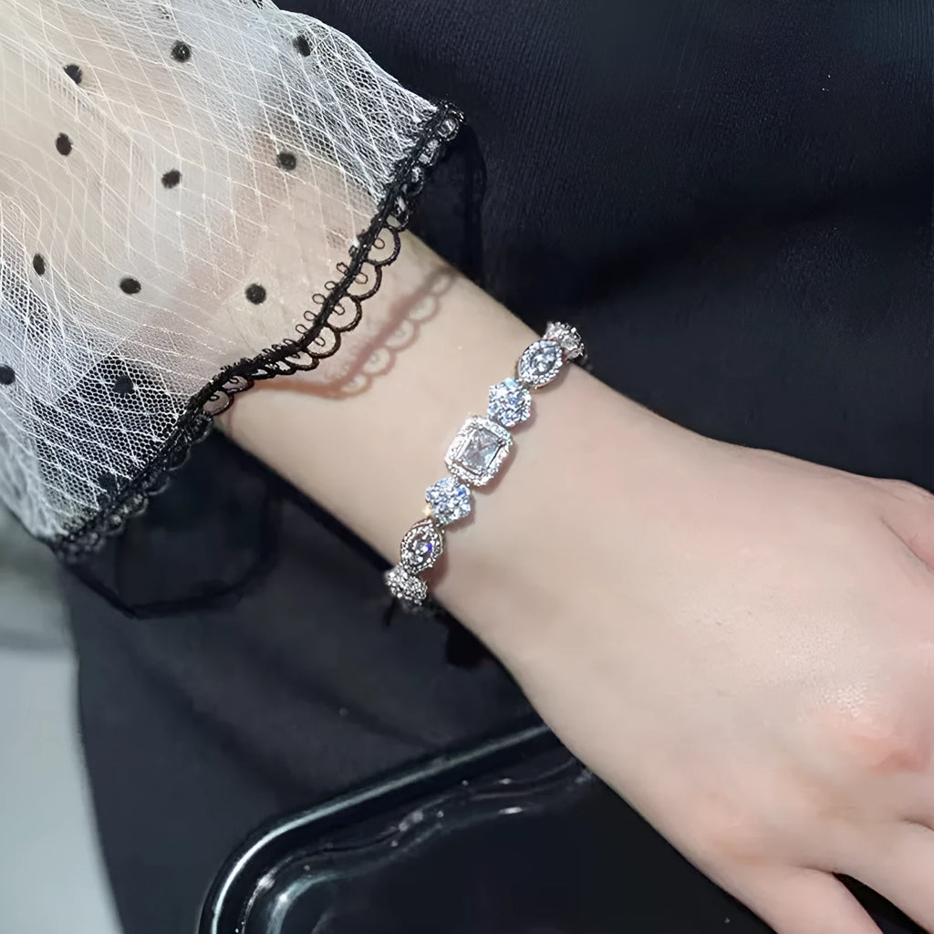 Women's sterling silver-plated bracelet with zircon stones on a geometry-patterned chain.