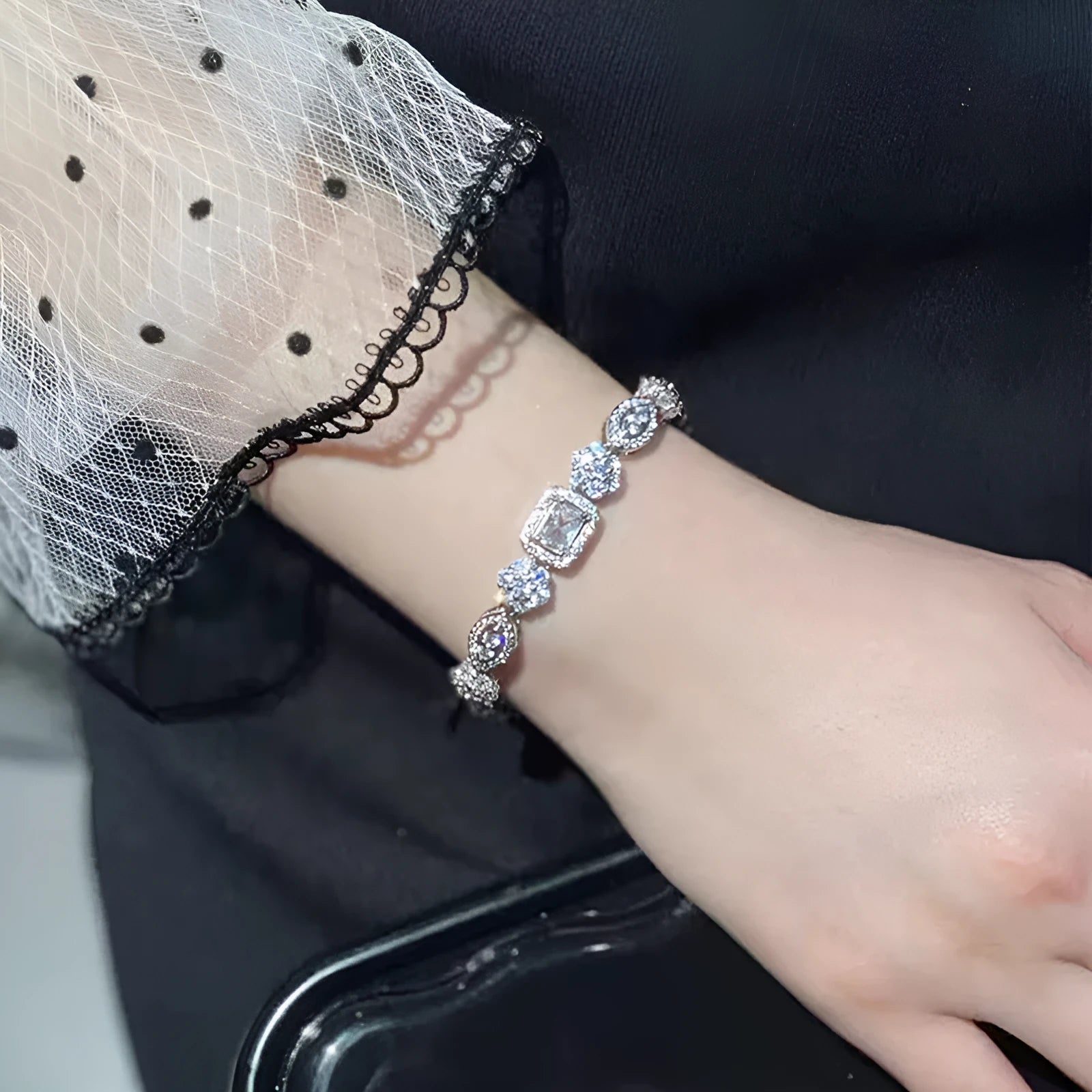 Women's sterling silver-plated bracelet with zircon stones on a geometry-patterned chain.