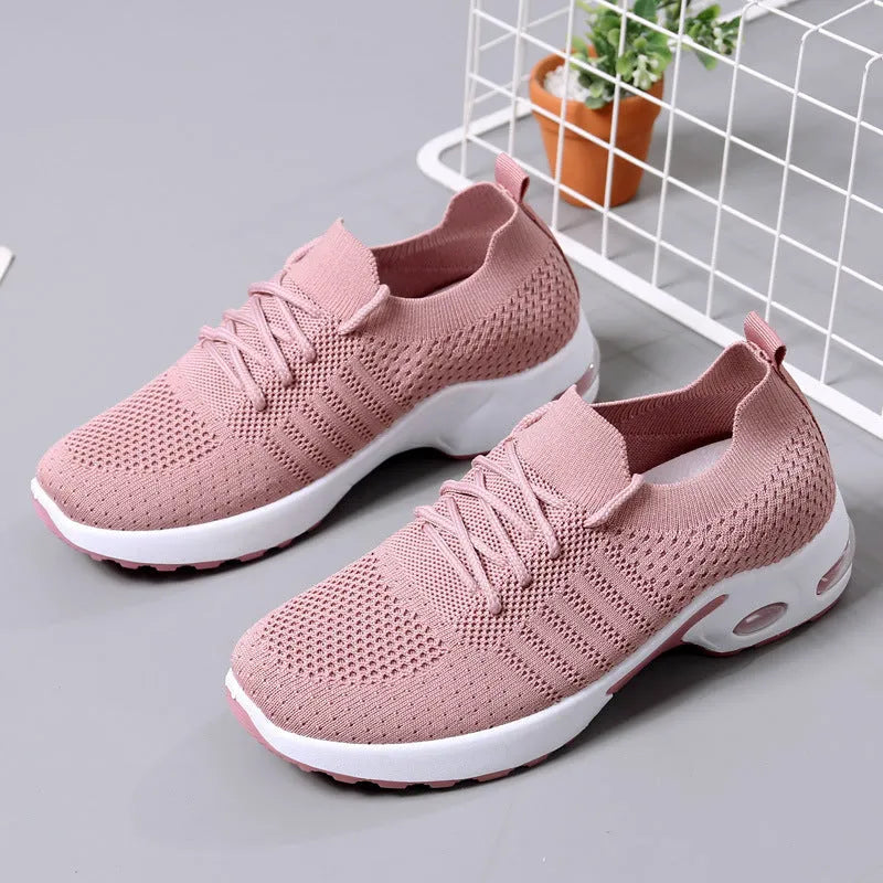 Women's black mesh casual sneaker with round toe, lace-up front, and a light-coloured soft sole.