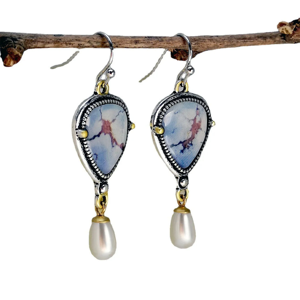 Retro blue women's drop earrings with geometric shape, synthetic opal and pearl details on electroplated metal.