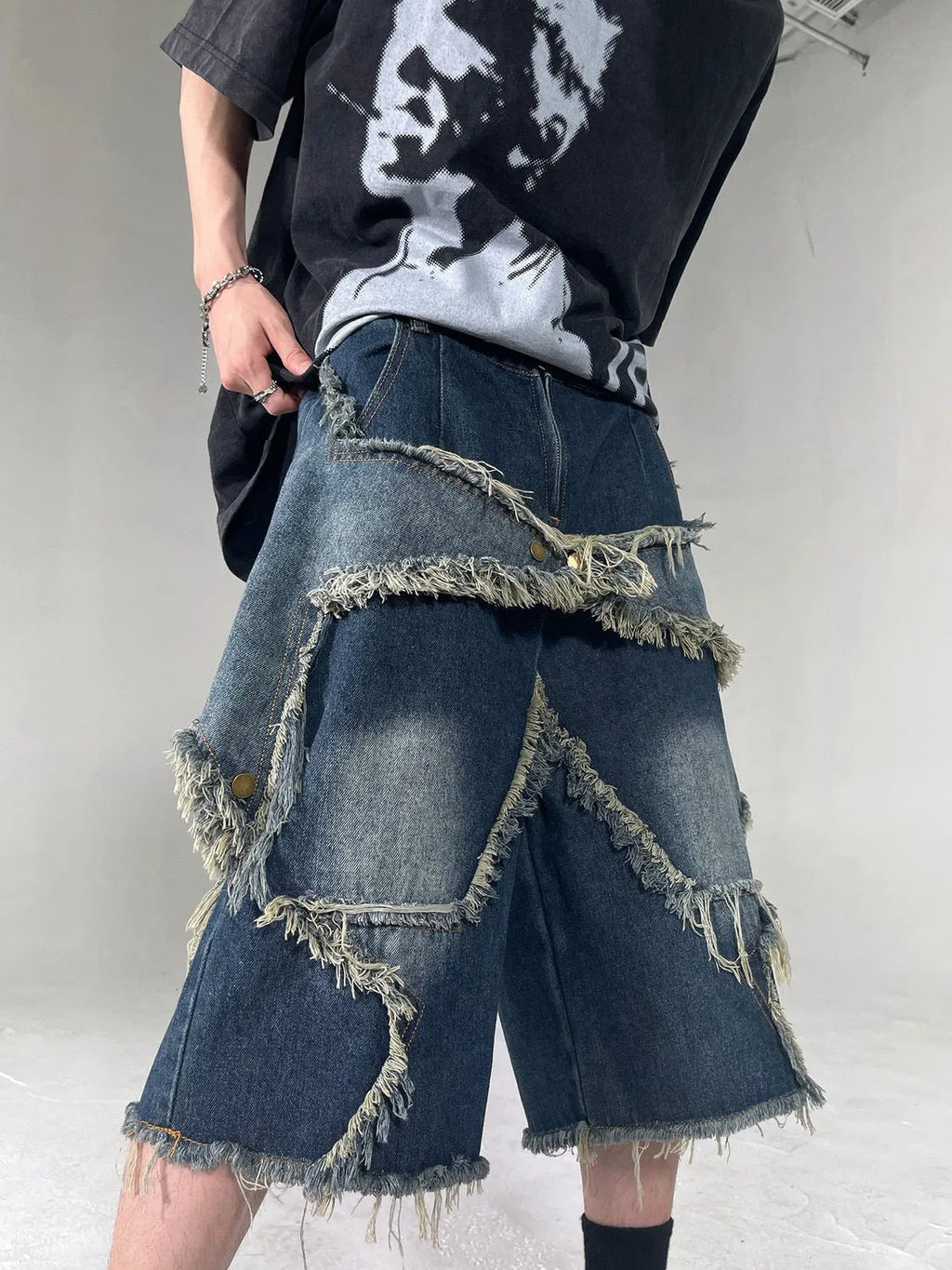 Blue cotton denim shorts for men with frayed hem detailing and five-pointed star patch, loose fit retro style