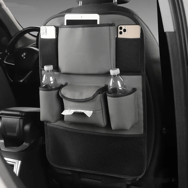 Black leather car seat back storage bag hanging on a vehicle seat.