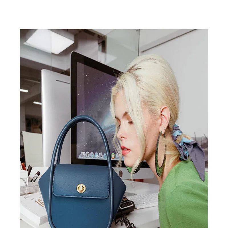 Women's leather wing handbag in blue with buckle decoration and shoulder strap