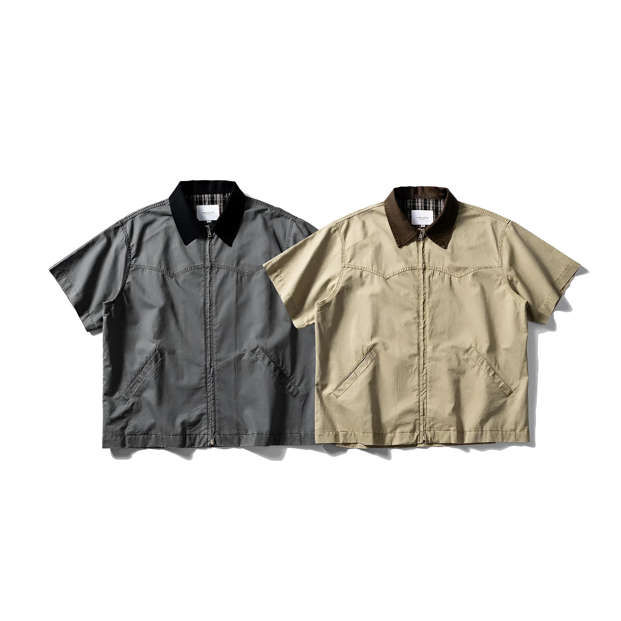 Loose grey short sleeve overalls shirt with cardigan front on a hanger.